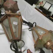 A pair of copper lanterns with wall brackets