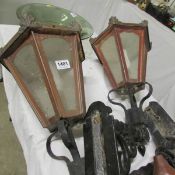 A pair of copper lanterns with wall brackets