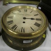 A brass ship's clock by Camerer Cuss & Co, (missing glass)