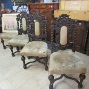 A set of 4 carved oak dining chairs