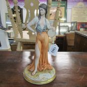 A signed porcelain figure of a gypsy girl