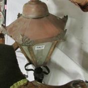 A copper lantern with wall bracket