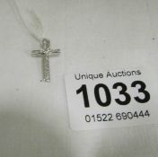 A 14ct white gold and diamond cross