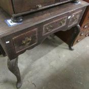 An early 19th century 3 drawer oak desk on pad feet