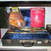 A B & M Champion trumpet with books and in case