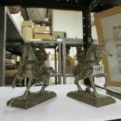 A pair of metal horse and riders