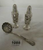 A silver spoon and 2 Mexican silver pepper pots