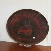 A large oval Oast House Farm wooden sign