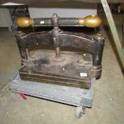 A cast iron paper press with solid bronze ends