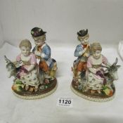 A pair of early German porcelain boy and girl with goat figures