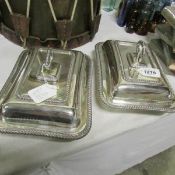 A pair of silver plated tureens and covers