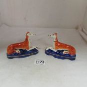 A pair of Staffordshire greyhound inkwells