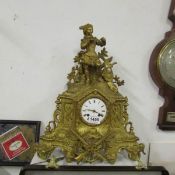 A gilded clock surmounted figure