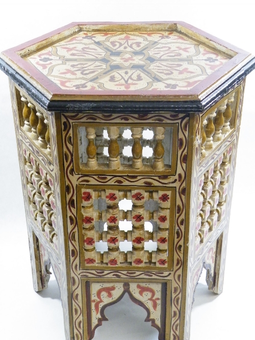 An unusual Moorish hexagonal table with spindle worked open panels and profuse handpainted
