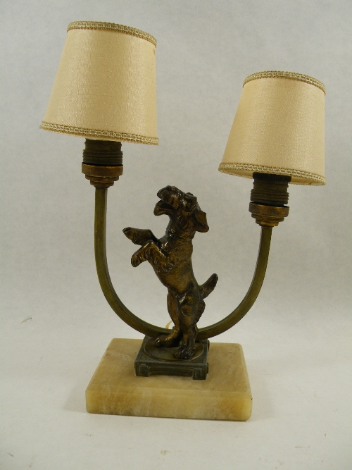 A bronzed spelter Art Deco twin light fitting table lamp with a central terrier on hind legs mounted