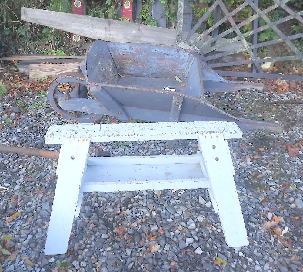 19th. C. wheel barrow and carpenter's bench.