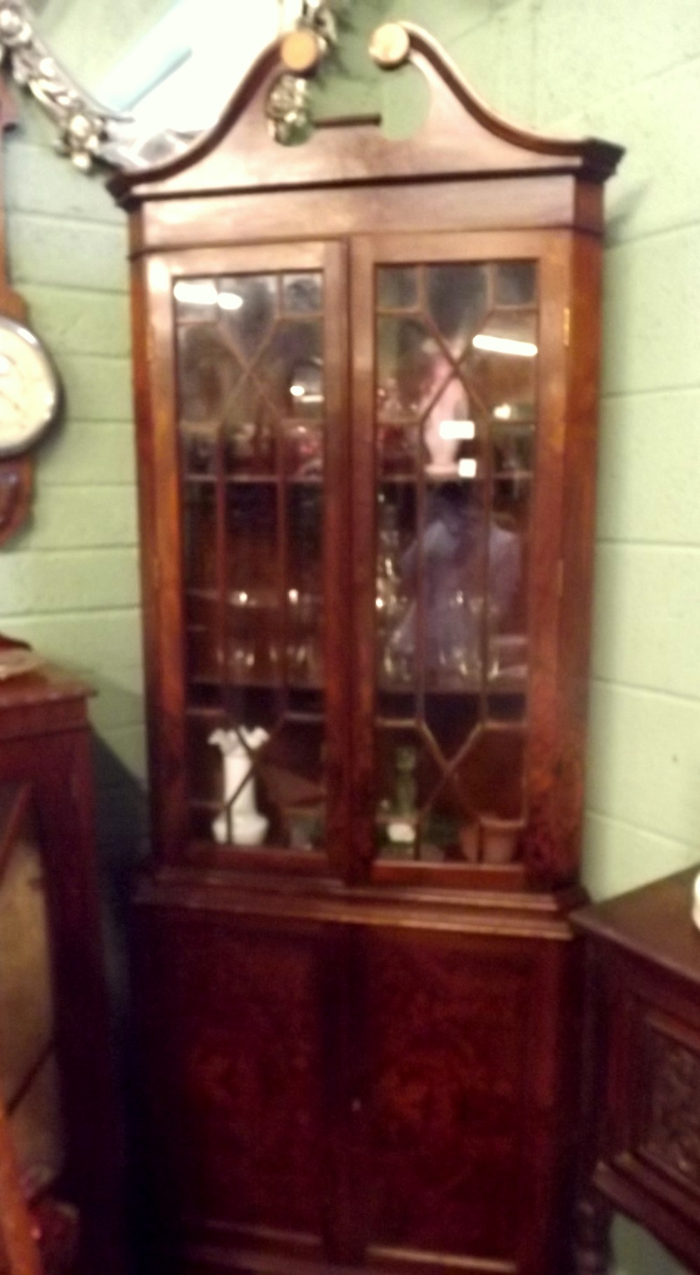 Edwardian walnut corner cupboard the two astragal glazed doors over two panelled doors in the