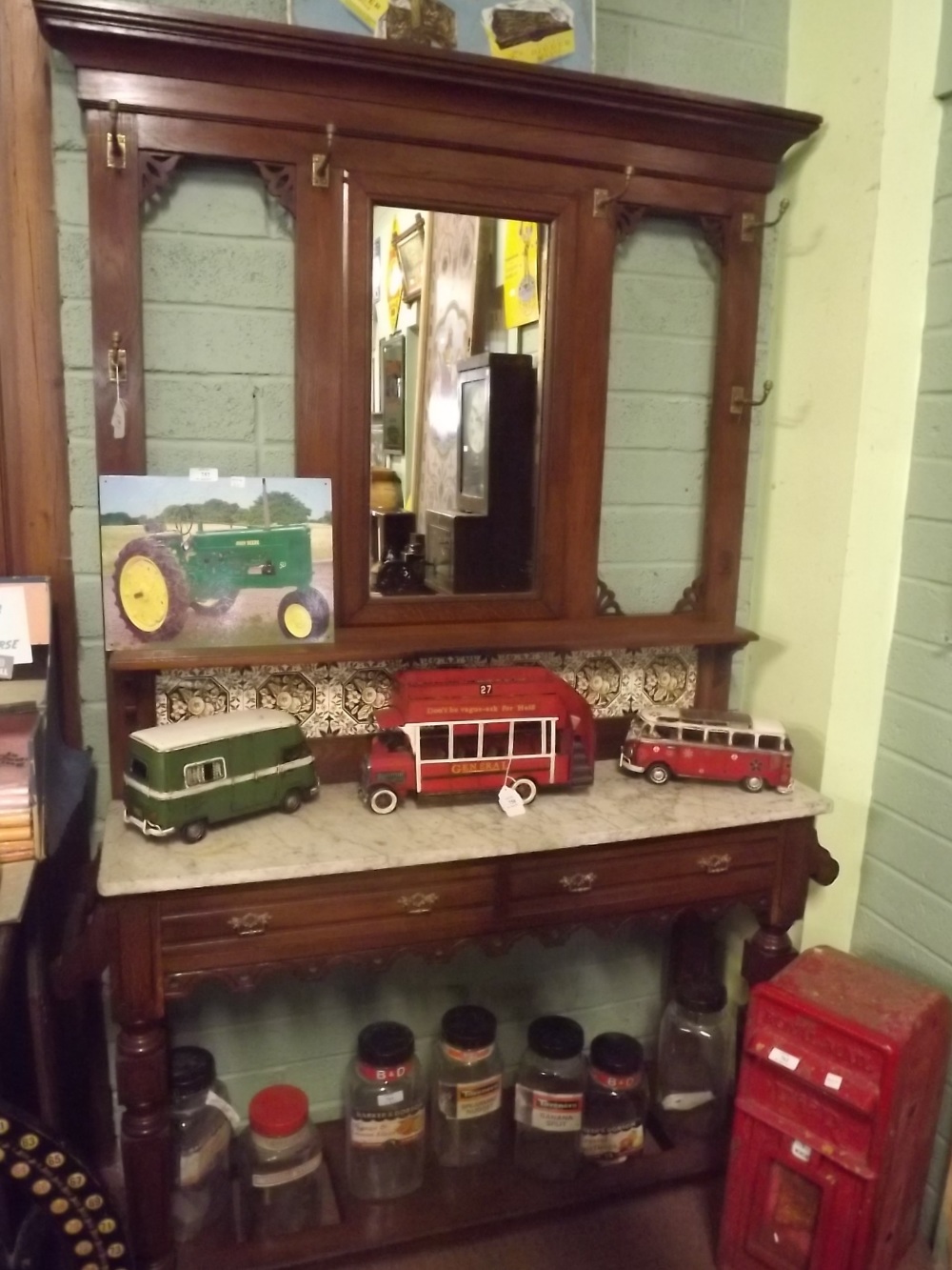 Victorian oak hallstand the back with mirror and tiles over a marble top and two drawers in the