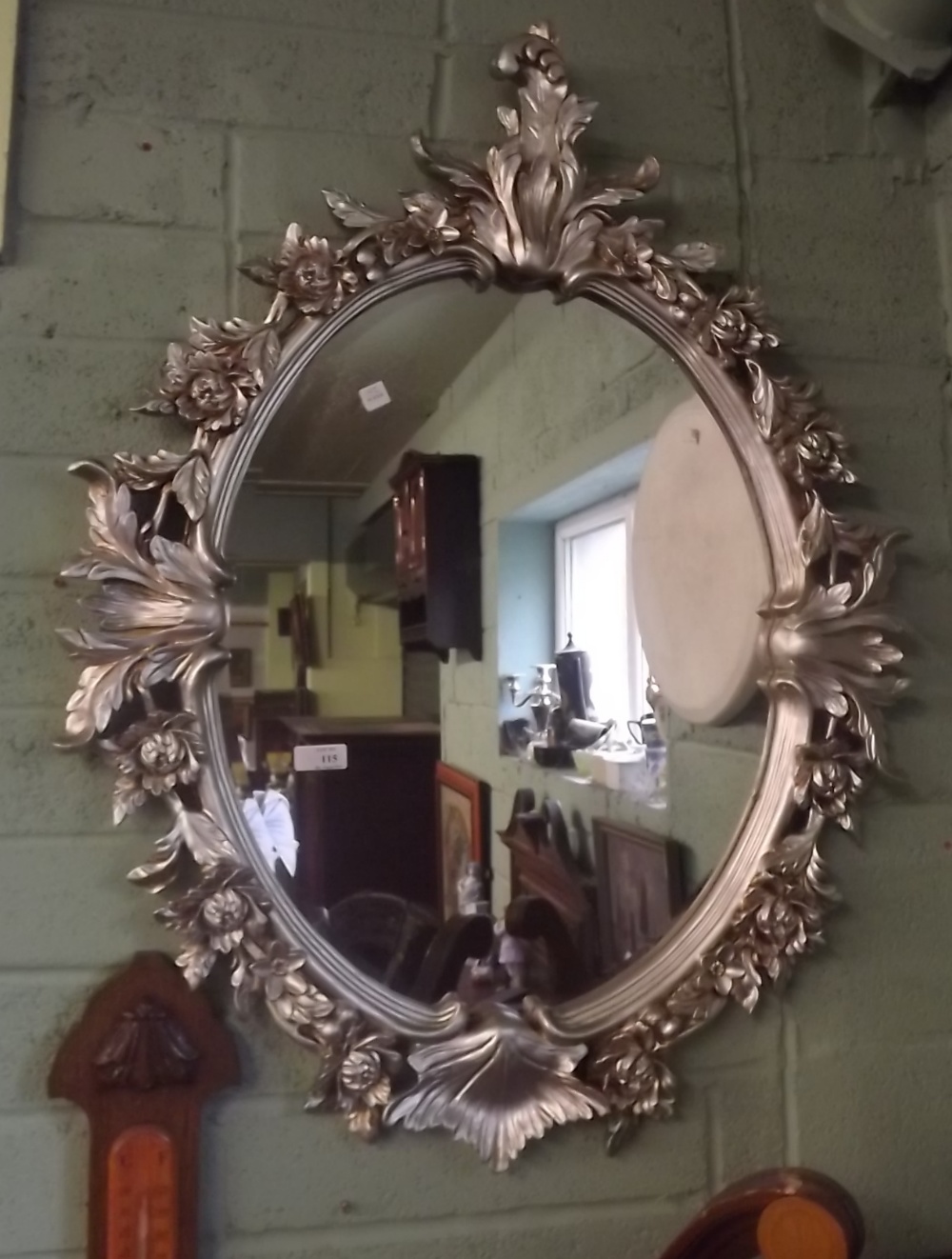 Decorative mirror of oval form.