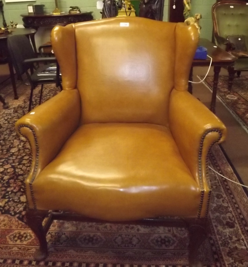 Leatherette upholstered wing backed chair in the Georgian style.