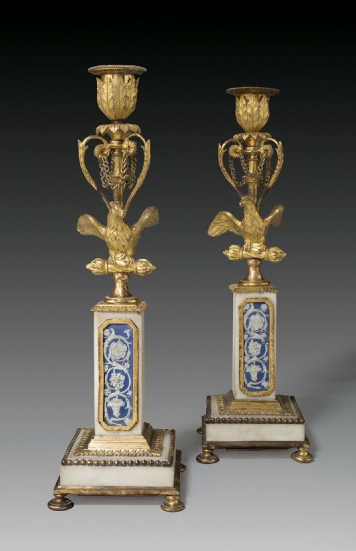 Berlin bronze founder ()  TWO CANDLESTICKS WITH WEDGWOOD INLAYS. 1780/90  Gilt bronze; marble;