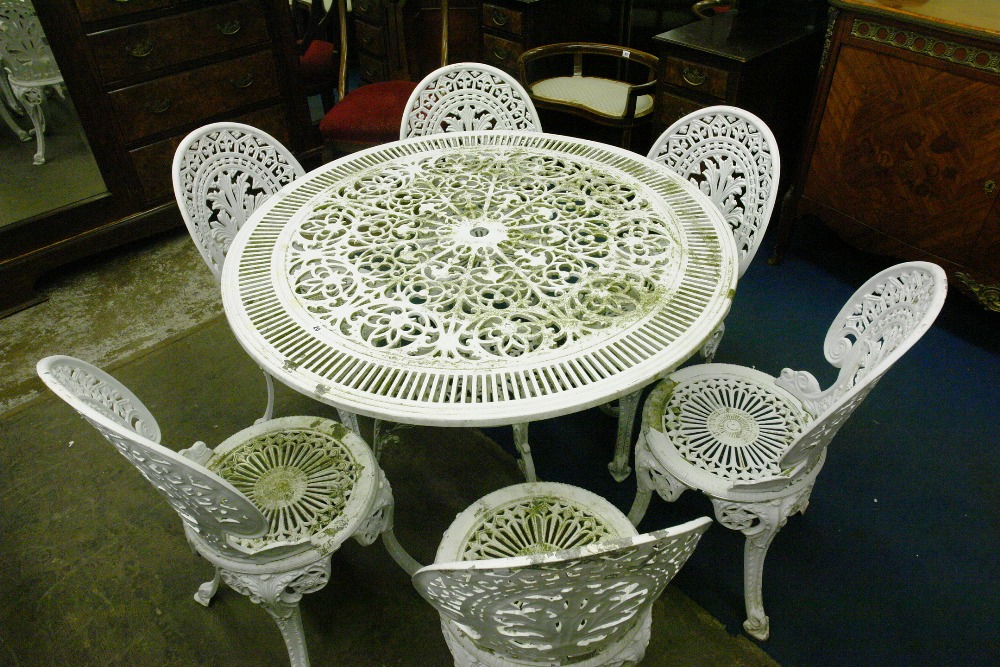 REPRODUCTION 20TH CENTURY VICTORIAN STYLE CAST IRON GARDEN ABLE AND SIX OPEN FRET CHAIRS