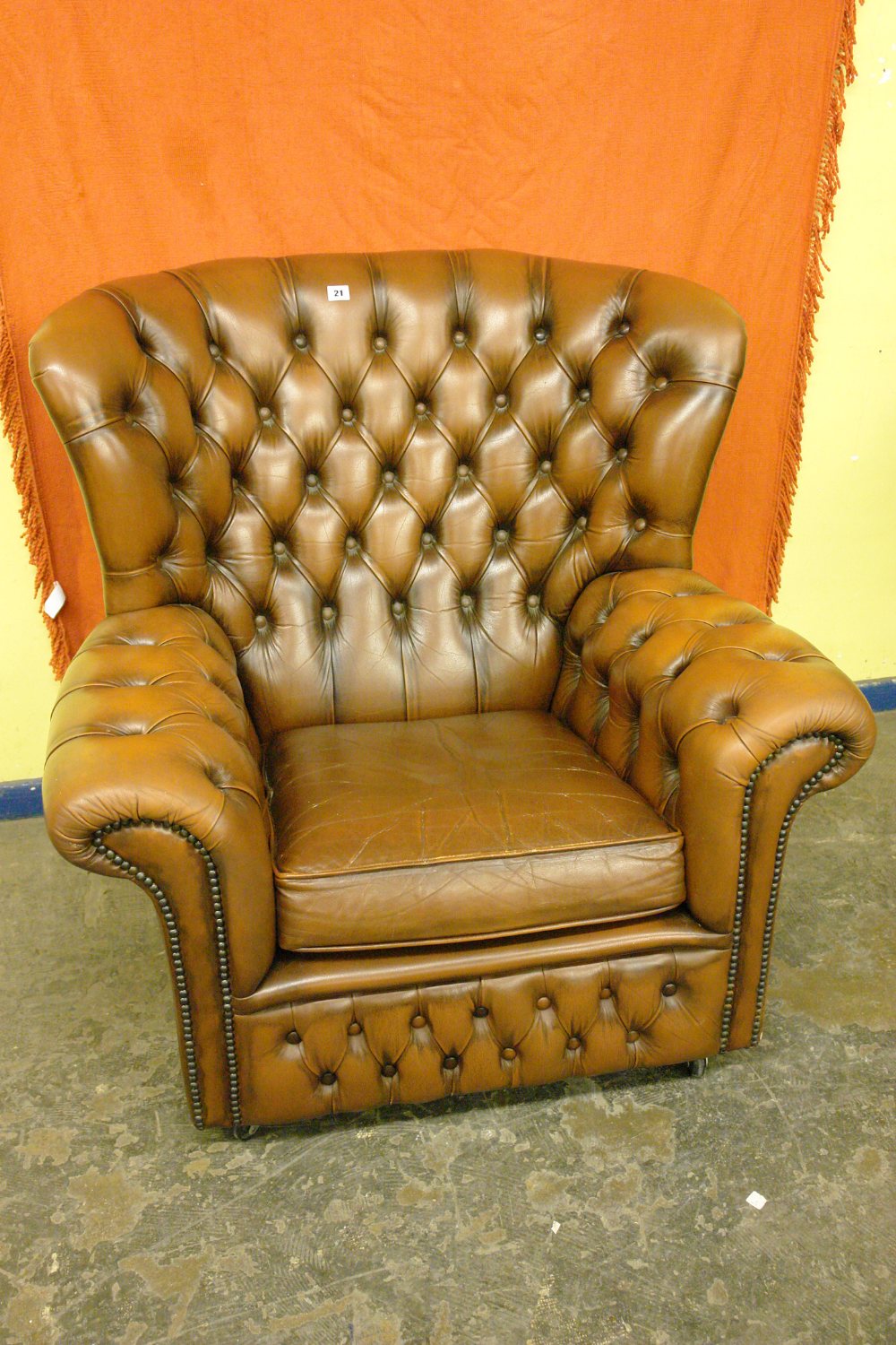 BROWN LEATHER BUTTON BACKED ARMCHAIR
