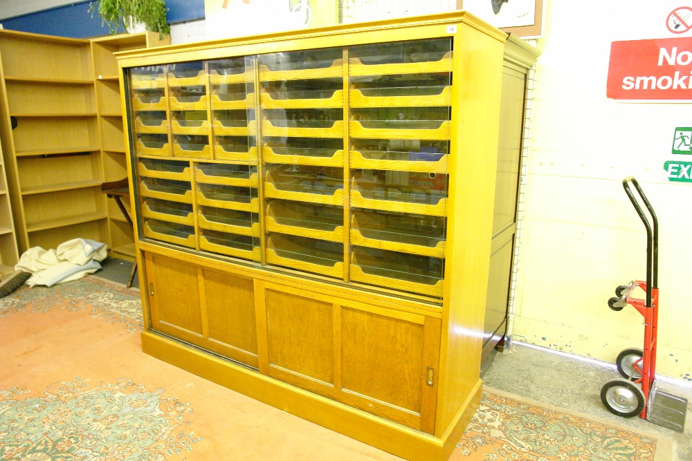 GOOD QUALITY LIGHT OAK HABADASHERY CABINET FITTED WITH SLIDING TRAYS BEHIND GLAZED DOORS 181CM X