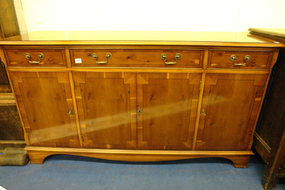 REPRODUCTION YEW SIDE CABINET FITTED WITH THREE DRAWERS OVER 3 CUPBOARD DOORS 150CM X 83CM H