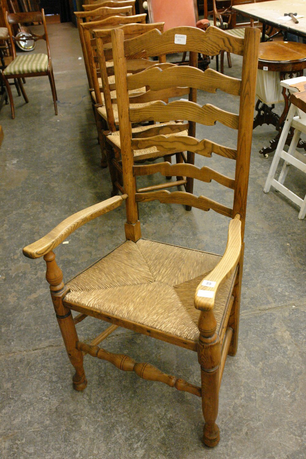 19THC ELM AND ASH LANCASHIRE TYPE ELBOW CHAIR WITH WAVY LADDERBACK