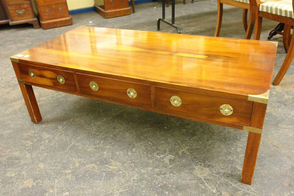 YEW WOOD OBLONG COFFEE TABLE WITH BRASS CORNER MOUNTS AND MILITARY TYPE FLUSH HANDLES 122CM X 58CM