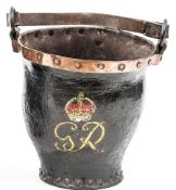 A shaped leather fire bucket, copper rim, and studded base, leather carrying handle on rings, with