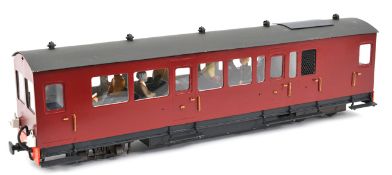A 16mm gauge electric (battery powered) diesel railcar. A dual ended bogie unit painted in maroon