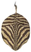 A scarce Zulu war chief?s Quagga hide war shield, Isihlangu, 42? x 31?, with stitched hide top.