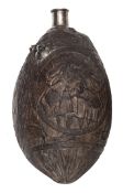 An 18th century coconut flask, carved overall in oval wreath panels, with ?GR? cypher and lion with