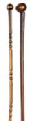 Two 19th century Zulu two tone hardwood staffs, one 32” overall with a slightly offset ball 2½”