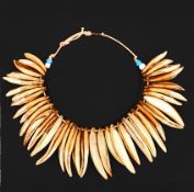 A large 19th Century Zulu status necklace comprising rows of lions’ teeth, approximately 10”