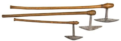 Three Shona axes, with characteristic half moon blades with flat tangs set into hardwood hafts,