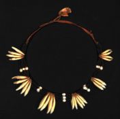A 19th Century Zulu or Xhosa status necklace, diameter 9”, comprising six bunches of jackal’s