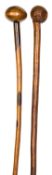 A two tone hardwood Zulu knobkerry, 32½”, with head 3” exhibiting one age crack, and a knobkerry