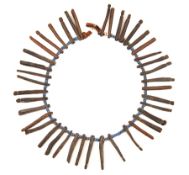 A 19th Century Zulu charm necklace, diameter 7”, consisting of lengths of slim wood shaped at the