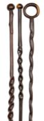 Three early 20th century Zulu darkwood staffs, all with candy twist decoration to shafts, one with