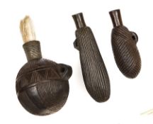 Three wooden Shona snuff containers, all decorated with grooved engraving, one ball shaped, with the
