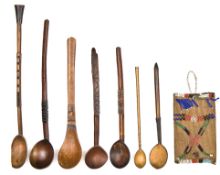 Seven small Zulu wooden spoons, the largest 15½”, all with some decoration on the handles coloured