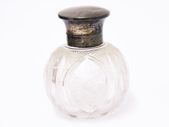An etched glass bottle with a hallmarked silver top. H13cm