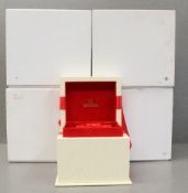 FOUR OMEGA WRIST WATCH BOXES CIRCA 2000s Outer boxes, inner boxes with red felt interiors and a