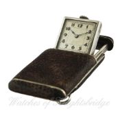 A LEATHER COVERED SOLID SILVER PURSE WATCH CIRCA 1920s D: Silver dial with applied luminous Arabic