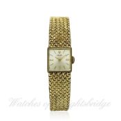 A LADIES 14K SOLID GOLD ROLEX BRACELET WATCH CIRCA 1950s D: Silver dial with applied hour