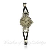 A LADIES PLATINUM AND DIAMOND COCKTAIL WATCH CIRCA 1930`s D: Silver dial with applied Arabic