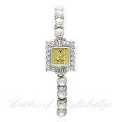 A LADIES WHITE GOLD, DIAMOND & PEARL ROYAL DIAMOND OF GENEVA BRACELET WATCH CIRCA 2008 D: